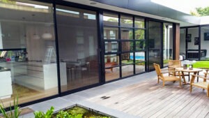 Vista One - Foldaway Series on a large glass wall to a large outdoor deck living space.