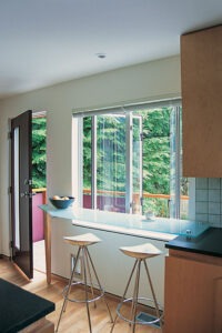 Vista One - Rollaway Series on kitchen window infront of a breakfast bar.