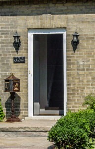 Vista One - Rollaway Screen single front door brick home.