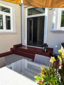 Vista One - Foldaway Screen large double door opening to outdoor entertaining space on large deck.